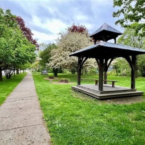 A gazebo and tree-lined walkway in the Fall Creek neighborhood of Ithaca